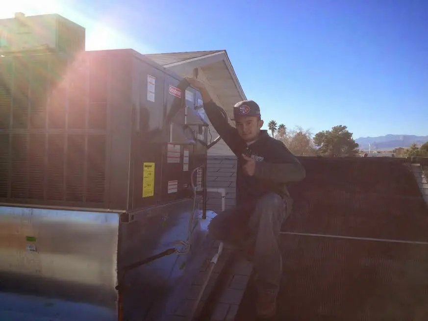 HVAC technician performing HVAC Inspection on a rooftop unit in American Canyon